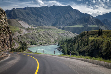 asphalt road, highway in the mountains. Blue sky and big white clouds. summer landscape