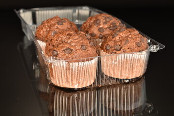 Chocolate muffins, close-up, on a black background.