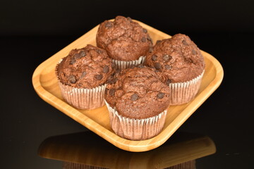 Chocolate muffins, close-up, on a black background.
