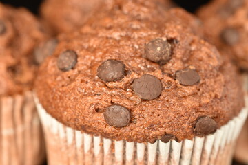 Chocolate muffins, close-up, on a black background.