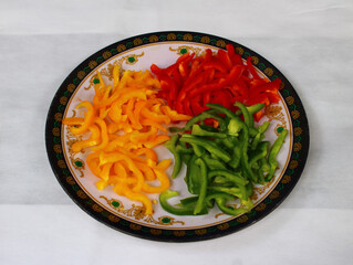 Colorful bell peppers, chopped and lying on a plate