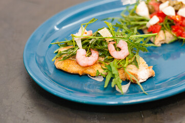 Bruschetta with shrimp, arugula, tomatoes, cheese and sauce, close-up, high Italian cuisine