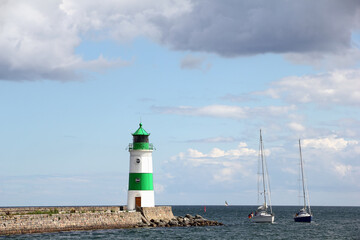 Obraz premium Lighthouse of Schleimünde at Western coast of Baltic Sea and Sailing boats