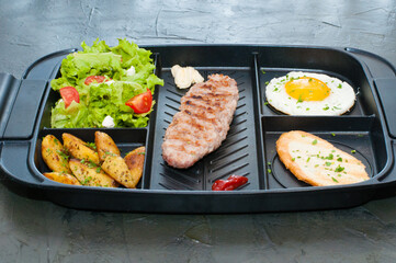 Breakfast, cutlet or steak, tomato salad, fried potato, crouton and fried egg