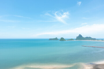 Naklejka na ściany i meble Sea and beach with blue sky background on a calm day.
