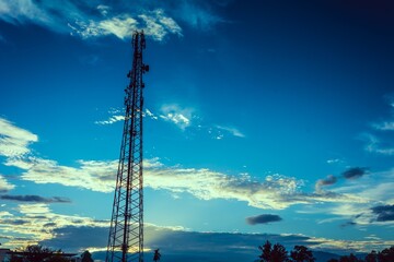 Telecommunication cellular tower at sunset in cool color tone.