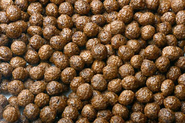 Breakfast cereal balls with chocolate on a white background