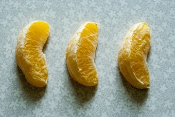 three orange slices on a light background
