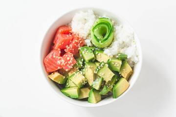 Hawaiian poke bowl with smoked salmon lox, avocado, white rice, cucumber and sesame seeds. Bright and airy feel 