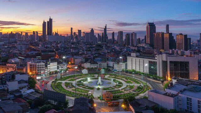 Night to day time lapse of roundabout named Wongwian Yai, background with Bangkok city during night to day
