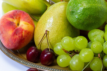 Assortment of exotic fruits on a tray close-up. Healthy lifestyle concept.