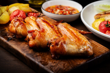 Delicious grilled chicken wings and vegetable salad