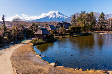 Japanese traditional house at Oshino Hakkai village with Mount Fuji in background.