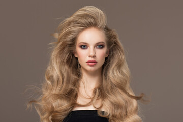 Portrait of a blonde girl with long beautiful wavy hair