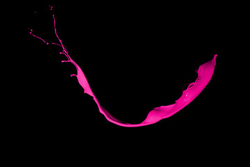 Isolated shot of pink paint splash on black background.