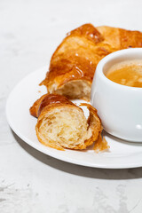 espresso and fresh croissants, vertical closeup