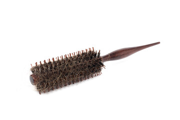 Comb with hair remnants attached after use on a white background