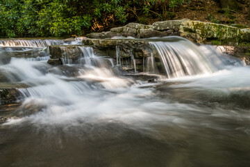 Obraz premium Stock photo of small waterfall in the mountains