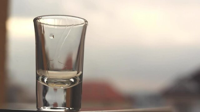 Accelerated footage of shot of spirit being drunk. Alcohol consumption concept. Beverages concept. Healthcare concept.
