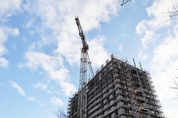 Construction site of a skyscraper building with a big crane, copy space
