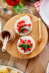 Grilled camembert cheese with strawberry, honey and basil leaves, delicatessen, camembert cheese fondue on the dinner table.