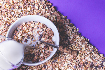 plate full with granola and pour milk