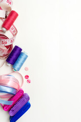 Sewing tools, tailoring and fashion concept. Satin ribbons, thread, accessories on the table, top view. 