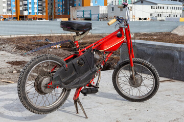 Restored Bicycle with a motor, red moped, manufactured in the Soviet Union