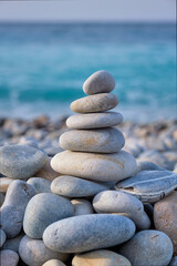 Zen meditation relaxation concept background - balanced stones stack close up on sea beach