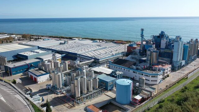 Industrial background with large chemical factory near Catalan town of Mataro on Mediterranean seashore, Spain
