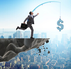 Businessman chasing money on fishing rod