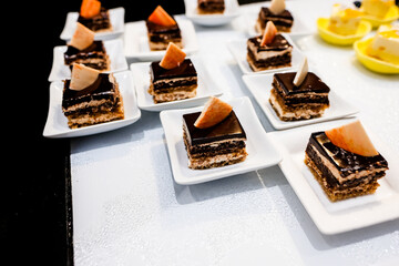 Small chocolate cakes in cups on a cooler.
