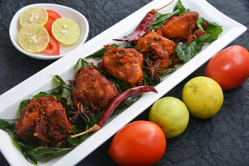 Fried chicken Kebab, Kerala Chicken fry or 65 is hot and spicy crispy chicken dish South India. Non vegetarian starter or quick snack. A popular authentic roasted dish deep fried Indian spices.