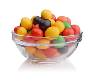 Multi-colored sweets in a glass bowl isolated on white.
