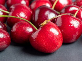 close-up of bright juicy fresh cherries on a dark background. Delicious and healthy berries, healthy food, vegetarianism