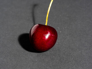 bright juicy ripe cherry berry isolated on a dark background