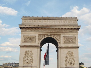 Fototapeta na wymiar Outside view of Arc de Triomphe with French Flag, Paris, France 2011