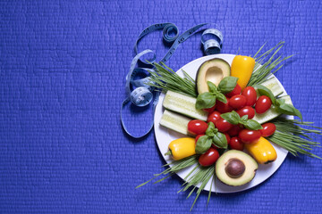 plate with vegetables stands on a purple background