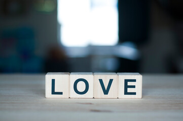 The word love on a wooden cube. Letter constructor