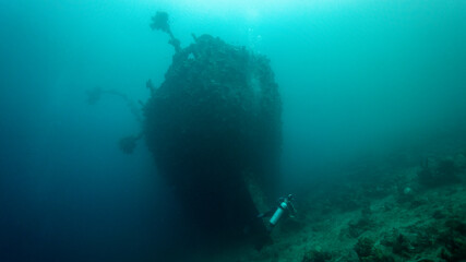 Fototapeta na wymiar The silhouette of the sunken steel giant rests in darkness. Munda (Solomon Islands)
