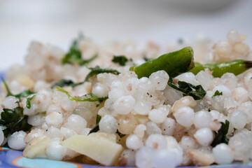 traditional maharashtrian dish sabudana khichdi with green chilly on top