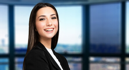 Smiling businesswoman portrait in a modern office