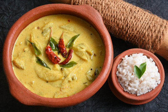 Traditional yellow mango curry or Mampazha Pulissery sweet and sour dish Kerala India . Made from organic raw ripe mango, coconut milk, seasoned with curry leaves, mustard, Indian red Kashmir chilli.