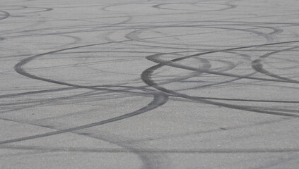 Background asphalt road with car tire skid mark on the track, abstract car drift tire skid mark texture.