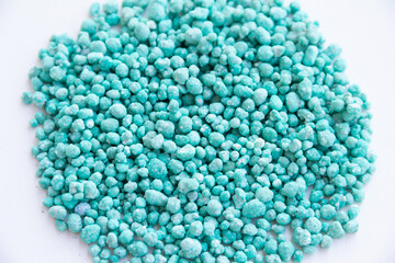 Green different shape chemical fertilizer granules.