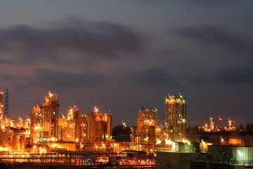 Fototapeta premium The light of a petrochemical factory that is normally produced on nights with full stars.