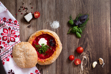 Top view of Ukrainian local meal red soup inside the bread (borsch)