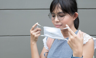 Portrait of Asian woman using mask for protecting COVID-19 or epidemic disease, when go outside.