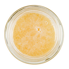 Linden honey in a glass jar. Isolated on a white background. View from the top.