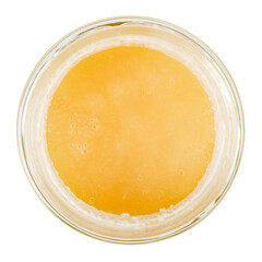 Forest honey in a glass jar. Isolated on a white background. View from the top.